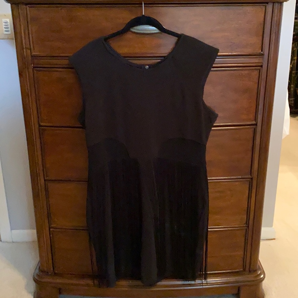 Black cocktail dress with fringe and torso mesh.
